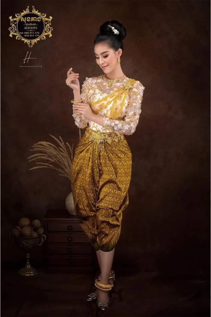 Phụ nữ Khmer trong bộ trang phục Sampot Chong Kben màu vàng đồng kết hợp cùng khăn Sbai thêu hoa văn tinh xảo